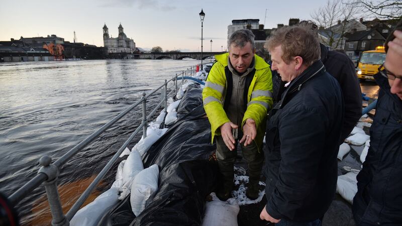 Kevin “Boxer” Moran with Taoiseach Enda Kenny on the banks of  the River Shannon in Athlone, Co Westmeath, discussing the   adjacent sandbag wall  keeping the river from flooding local houses, December 31st, 2015. File photograph: Alan Betson/The Irish Times