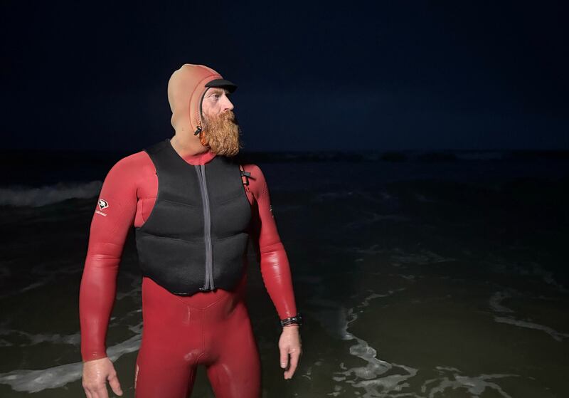 International big wave surfer Al Mennie swimming at Downhill Hill Strand beach, near Coleraine, on a summer night. He’s just released a new book,  “Night Swimming: How to swim through the darkness” on the wellbeing benefits of night swimming. Photograph: Chris Maddaloni/The Irish Times