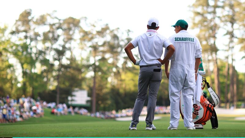 Xander Schauffele speaks to his caddie after finding the water at the 16th. Photo: Mike Ehrmann/Getty Images