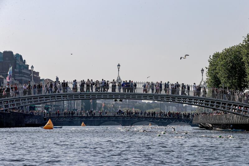 Liffey Swim makes its way under the Ha'penny Bridge. Photograph: Dan Sheridan/Inpho