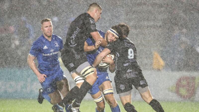 Leinster’s Caelan Doris is tackled by Dragons’ Leon Brown and Rhodri Williams during the Guinness Pro 14 game at the RDS. Photograph: Dan Sheridan/Inpho
