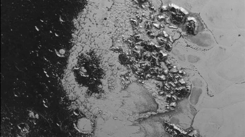 A newly discovered mountain range lying near the southwestern margin of Pluto’s Tombaugh Regio (Tombaugh Region), situated between bright, icy plains and dark, heavily-cratered terrain. Photograph: Reuters/Nasa.