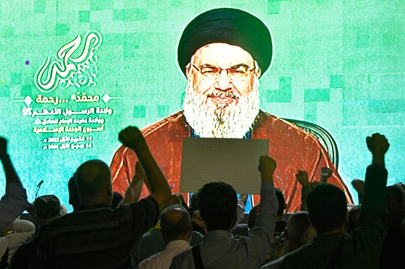 Hezbollah supporters listen to Hassan Nasrallah deliver a speech on a screen in the southern suburbs of Beirut in October. 