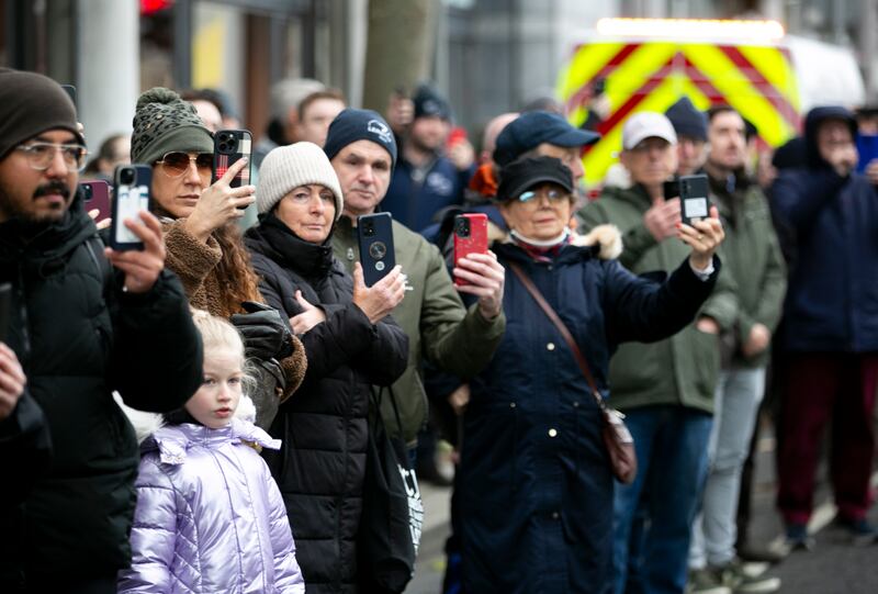 Members of the public watch as the funeral cortege for Shane MacGowan passes through Dublin city centre. Photograph: Gareth Chaney/Collins

