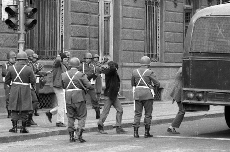 A group of Salvadore Allende's bodyguards are held prisoner by Carabineros, across the street from La Moneda. All of them were killed later. The photograph was taken during the aftermath of the coup d'etat led by Commander of the Army General Augusto Pinochet. Photograph: Horacio Villalobos/Corbis via Getty Images