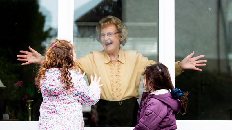 Elena (7) and Lucy (5) Tintori visiting their grandmother Sheela separated by glass. Photograph: Tom Honan