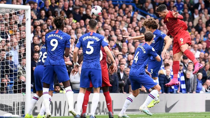Roberto Firmino  heads home Liverpool’s  second goal during the Premier League match at Stamford Bridge. Photograph: Laurence Griffiths/Getty Images