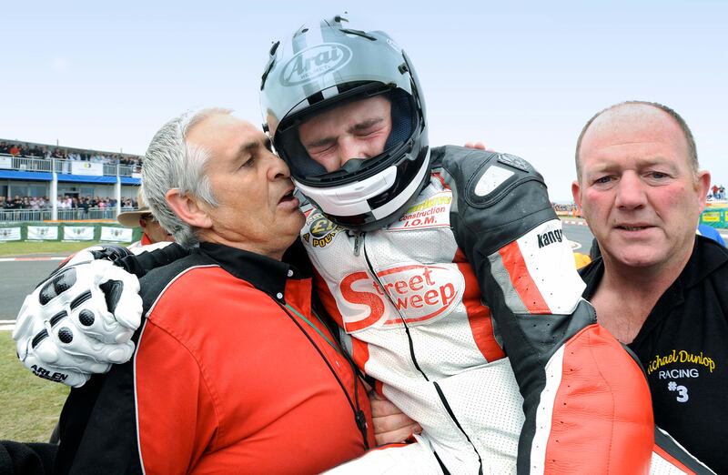 Michael Dunlop breaks down as he carried from his race bike after winning the 250cc race at the 2008 North West 200. Michael’s father, Robert, had been killed when he crashed as he practiced for the same race two days earlier. Photograph: Stephen Davison
