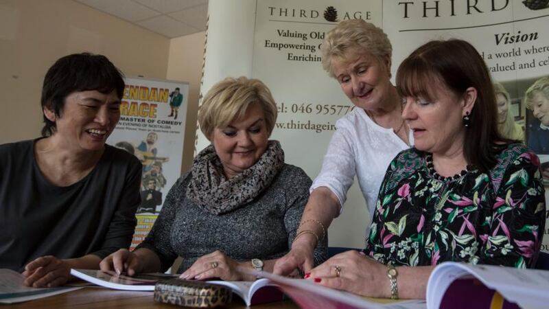 Extending the hand of friendship: Mary Nally (standing) at the Third Age Centre in Co Meath, with Mimi Pak from Hong Kong, Anna Filak from Poland, and her fellow teacher Linda Lafferty. Photograph: Brenda Fitzsimons