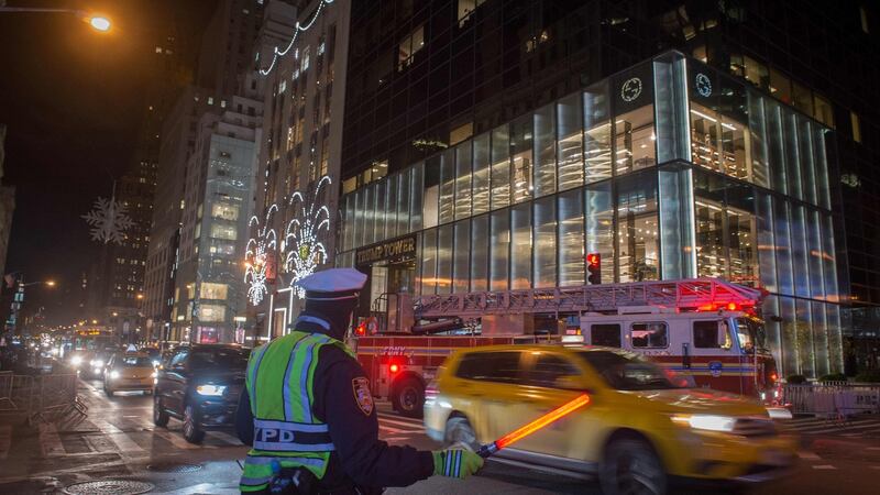 An NYPD officer directs traffic in front of Trump Tower, New York. Photograph:  Bryan R Smith/AFP/Getty Images