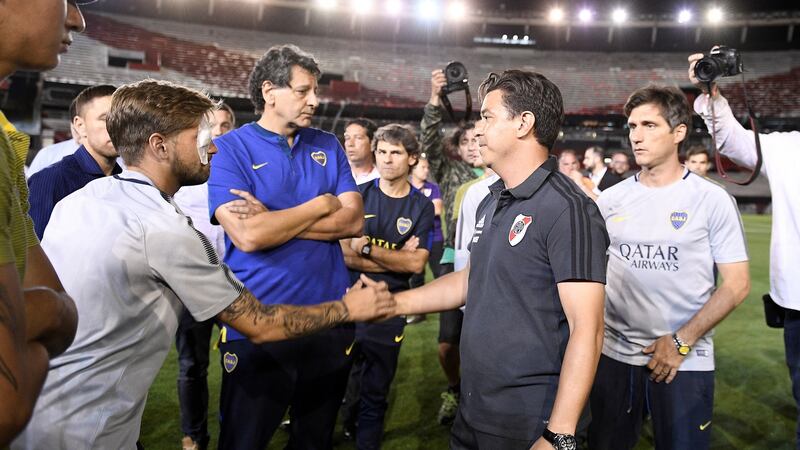 River Plate manager Marcelo Gallardo (right) shakes hands with Boca Juniors’  Gonzalo Lamardo after the  suspension   of the Copa Libertadores final second leg. Lamardo suffered an eye injury after the Boca bus was attacked. Photograph: Matias Napoli/EPA