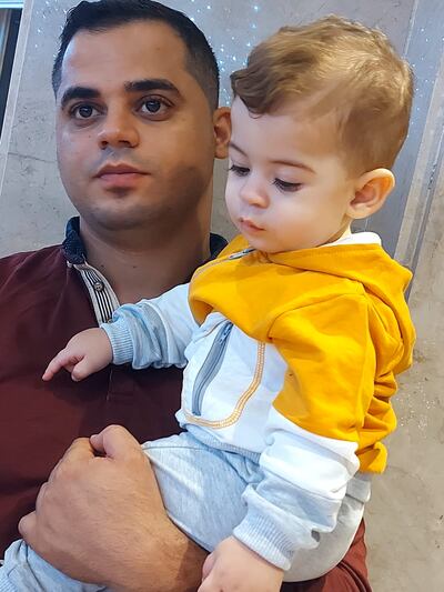 Ahmed Abumarzouq (29), who was killed last week in Gaza, holding his   son Faisal 
