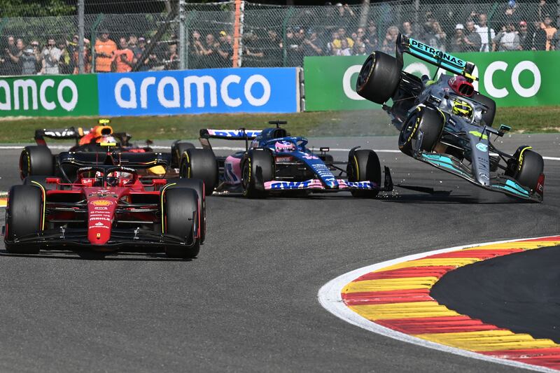 Mercedes' British driver Lewis Hamilton (right) collides with Alpine's Spanish driver Fernando Alonso (centre) near Ferrari's Spanish driver Carlos Sainz Jr (left) during the Belgian Formula One Grand Prix. Photograph: Getty