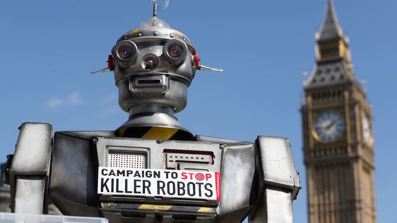 A robot distributes promotional literature calling for a ban on fully autonomous weapons in Parliament Square in London.