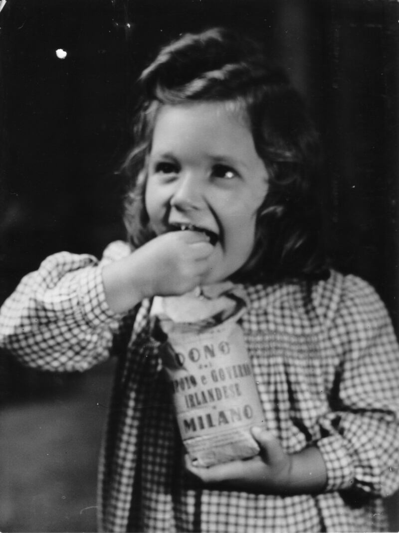 An Italian girl with a packet of Irish sugar distributed as food aid after the second World War; the inscription in Italian says, “A gift from the people and government of Ireland to Milan” Photograph: National Archives of Ireland