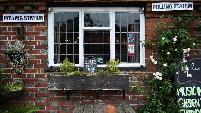 Signs are seen outside The Rock pub in the village of Chiddingstone Hoath, near Tunbridge Wells, south-east of London , as Britain holds a referendum to vote on whether to remain in, or to leave the European Union (EU). Photograph: Ben Stansall/AFP/Getty .