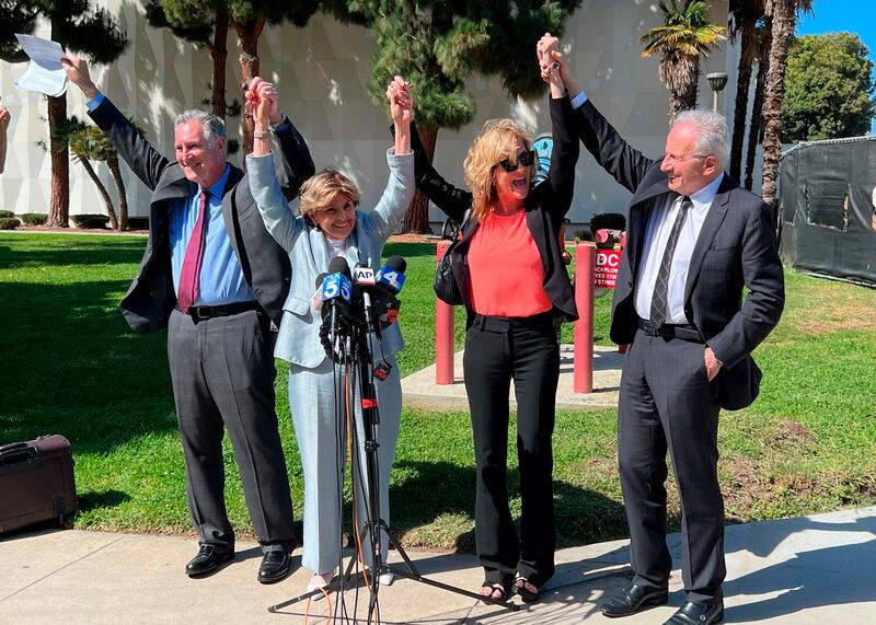 Attorneys John West and Gloria Allred with plaintiff Judy Huth and attorney Nathan Goldberg join arms following a verdict in Ms Huth’s favour in a civil trial involving actor Bill Cosby. Photograph: Richard Taber/AP