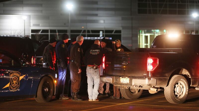 Police meet on Sunday at Kalamazoo Valley Community College after searching for a gunman involved in multiple shootings which left at least six dead. Photograph: AP
