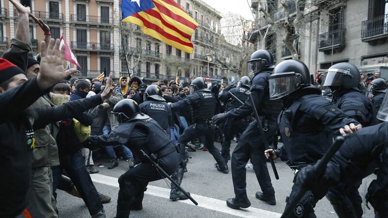 Catalonian riot police members and protesters clash during a protest against the detention in Germany of former Catalan leader Carles Puigdemont, at the Spanish Government Delegation in the Autonomous Community of Catalonia in Barcelona, Catalonia,  Spain, on Sunday. Photograph: Andreu Dalmau/EPA