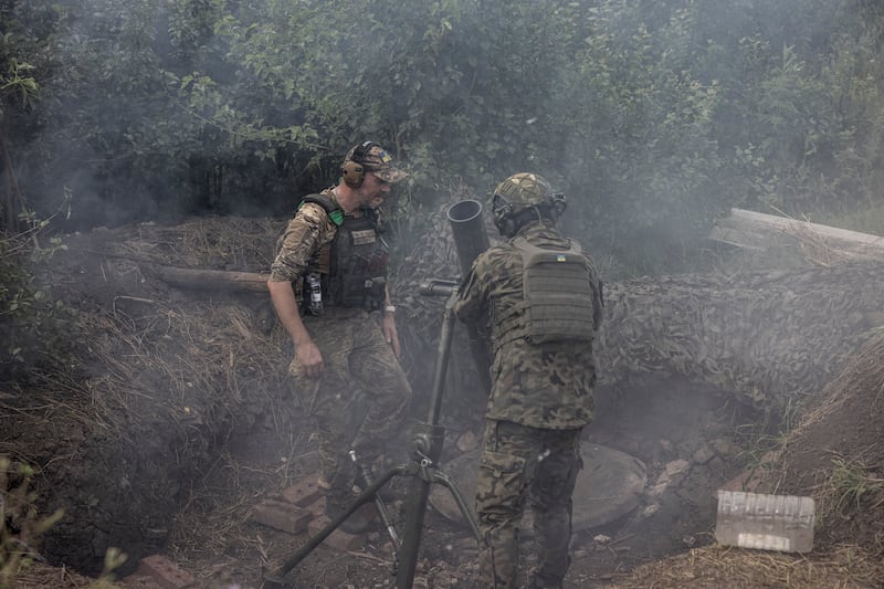 Members of a mortar team from the 24th Mechanised Brigade fire on a Russian trench position from the frontline in Ukraine’s eastern Donetsk region. Photograph: Finbarr O’Reilly/New York Times
                      