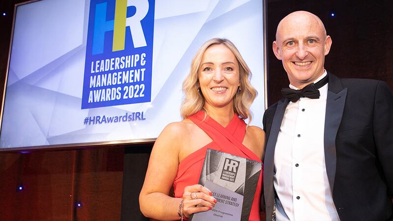 Nick Lawlor, managing director, Employee Financial Wellness, presents the Best Learning and Development Strategy award to Lisa Healy, Obelisk.