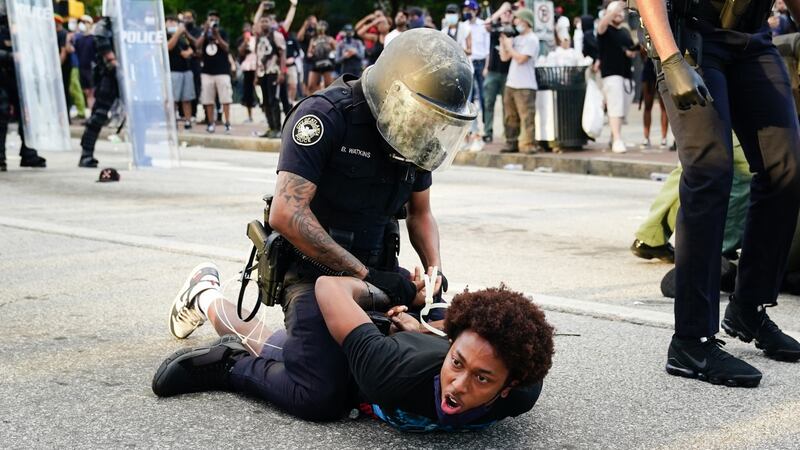Police detain demonstrators for being in the street during a protest in response to the police killing of George Floyd  in Atlanta, Georgia. Photograph: Elijah Nouvelage/Getty Images