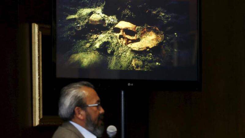 Raul Barrera, an archaeologist from the National Institute of Anthropology and History  speaks to the media at  news conference as a picture of a skull that was discovered at the ruins of the Templo Mayor Aztec complex is seen above him.  Photograph: Henry Romero/Reuters