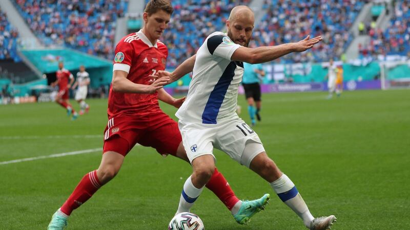 Russia’s Igor Diveyev challenges Finland’s Teemu Pukki. Photograph: Evgenia Novozhenina/AP