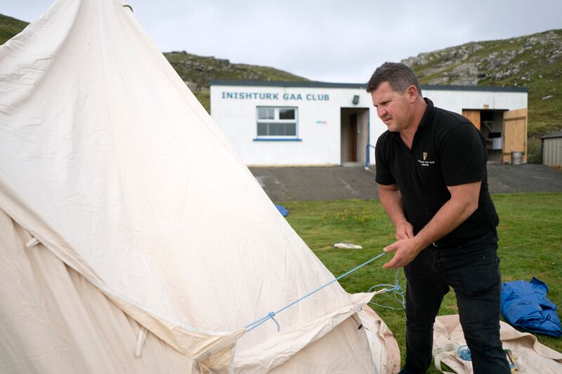 Australian John Smith sets up glamping tents for rental at Inishturk island’s GAA field. He and his wife, Cara, recently moved here from Tanzania, and work in the community centre. Photograph: Chris Maddaloni