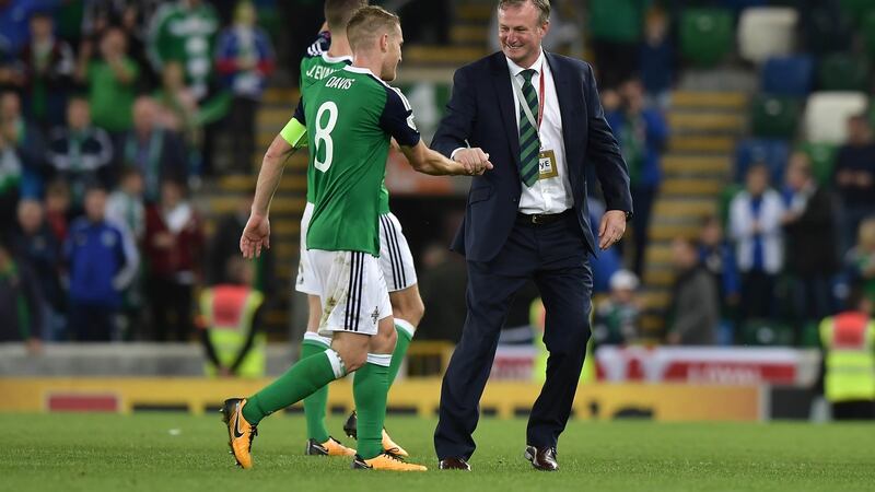 Northern Ireland manager Michael O’Neill celebrates with Steve Davis after the final whistle. Photograph: Getty Images