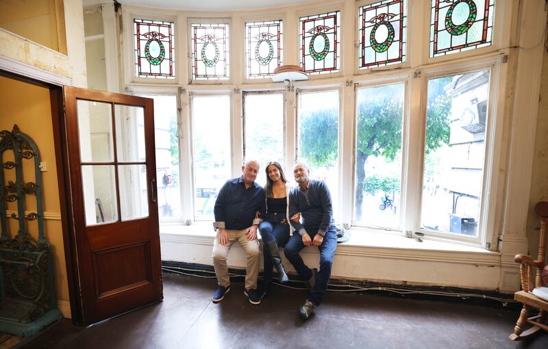 Peter Borza (left), Nicoletta Borza and Leo Di Vito in the first-floor bay window of their home O’Connell Street Lower.  Photograph: Bryan O’Brien/The Irish Times  