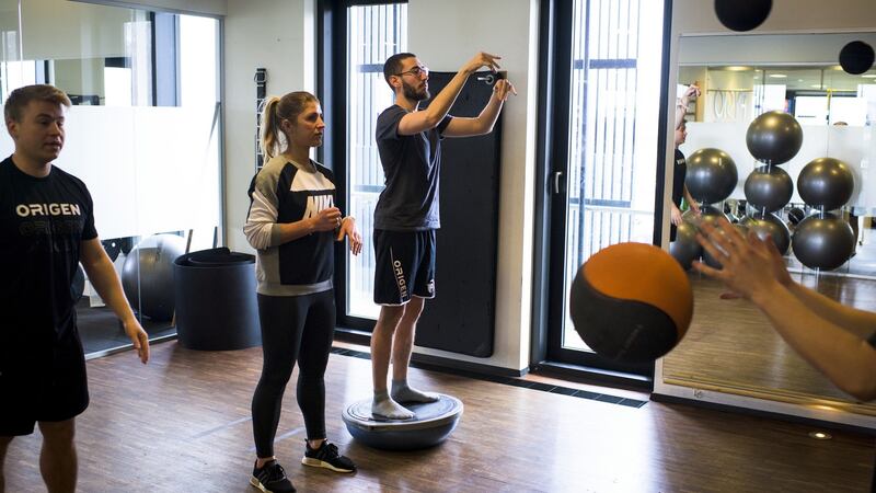Signe Find instructs Team Origen during an exercise with medicine balls. Photograph: Pete Kiehart/ The New York Times