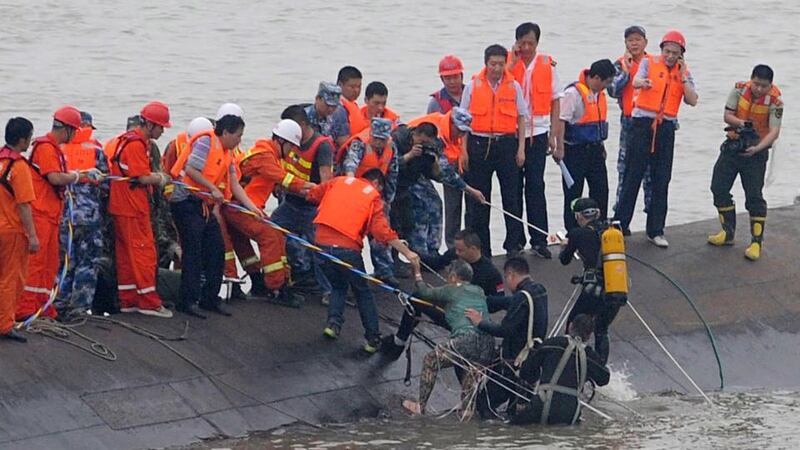 A survivor of the “Eastern Star” ferry disaster is rescued in the Yangtze River in China.   Photograph: Stringer/AFP/Getty Images