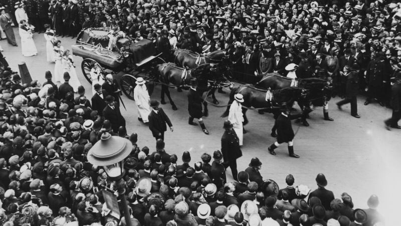 Crowds line the street as the funeral procession of English suffragette Emily Davison (1872 - 1913) passes through a London street,  June 14th, 1913. Davison died after she ran in front of Anmer, a horse owned by the King, at the Epsom Derby on 4th June. Photograph: Hulton Archive/Getty Images