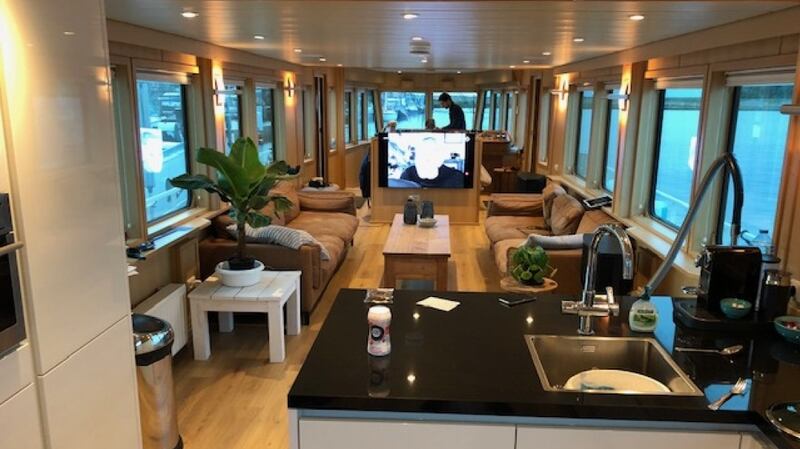 This three-cabin floating home is ready to be delivered to a new owner