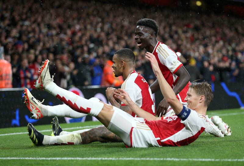 Arsenal's Gabriel Jesus (centre) celebrates with Bukayo Saka and Martin Odegaard the third against PSV. Photograph: Nigel French/PA Wire