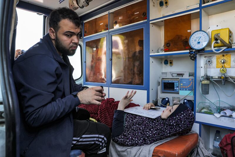 A young woman lies inside an ambulance waiting at the Rafah border crossing in the southern Gaza Strip before receiving medical care in Egypt. Photograph: Mohammed Abed/Getty Images