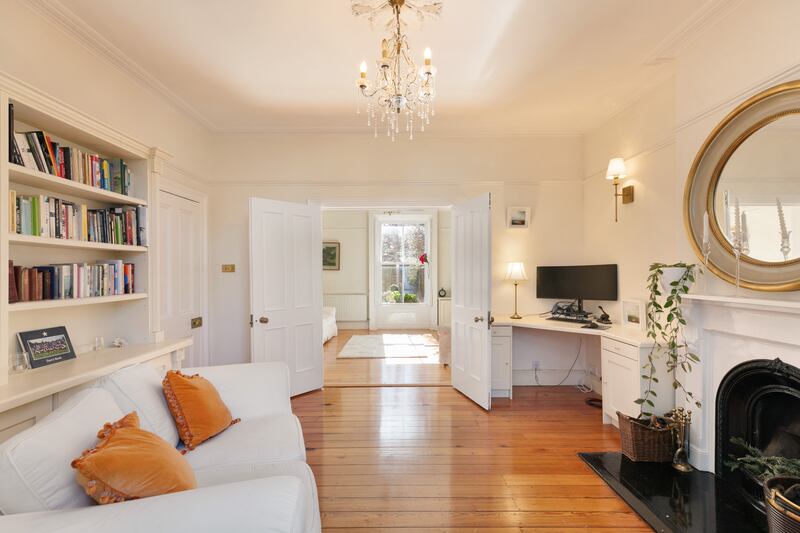 Fold-back double doors lead from the livingroom to a second sittingroom that could also be used as a diningroom or home office