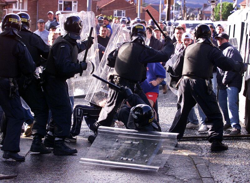 Protestants clash with police in riot gear in north Belfast as they tried to stop Catholic schoolchildren from attending the Holy Cross Primary School in the Ardoyne district of Belfast on the first day of the new school term in September 2001. Photograph: Paul Faith/PA Wire