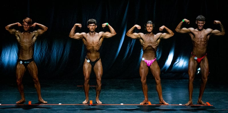 Competitors in the Junior Men's Bodybuilding contest perform the double-bicep pose. Photograph: Tom Honan 