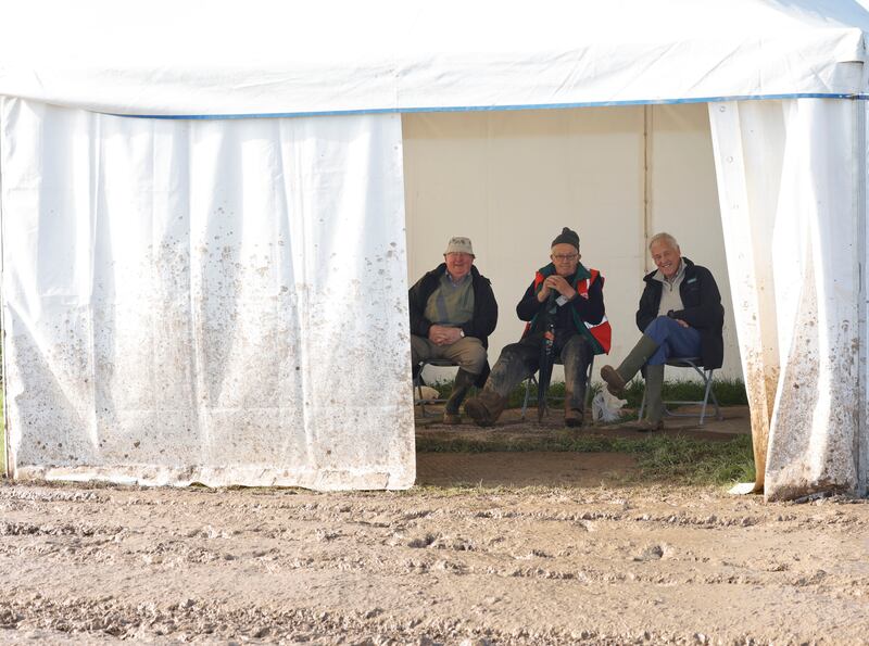 Three men watching the Senior Reversable competition from the comfort of a tent. Photograph: Alan Betson/The Irish Times