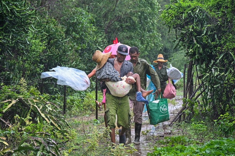 Residents of Playa Siboney, Cuba, evacuate under pouring rain. Photograph: Yamil Lage/AFP via Getty Images         