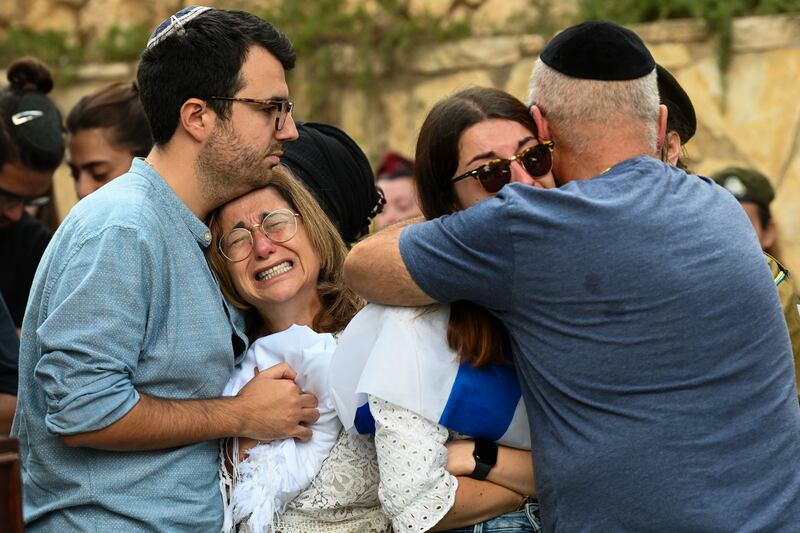 The mother, and immediate family of Valentin Ghnassia (23), who was killed in a battle with Hamas militants at Kibbutz Be’eeri last Saturday, grieve during his funeral. Photograph: by Alexi J. Rosenfeld/Getty Images