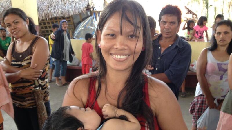 Grace Ausa and her two month old baby, at the Red Cross food distribution in Garawon. Photograph: Peter Murtagh