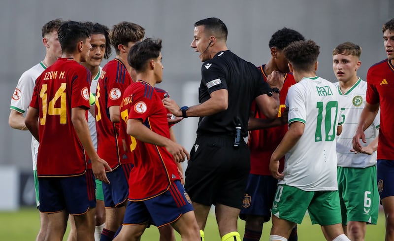 Referee Milos Milanovic separates players as tempers flare at the Nándor stadium on Saturday. Photograph: Nikola Kristic/Inpho