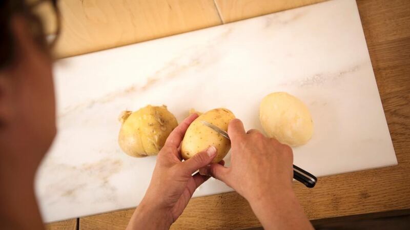 Score your spuds to help them out of their jackets. Photograph: Linda Nylind/The Guardian