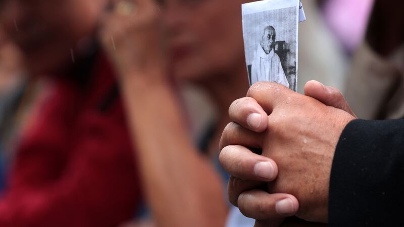 A mourner holds a picture of FrJacques Hamel outside Rouen’s cathedral during the funeral of the priest. Photograph: Joel Saget/AFP/Getty Images
