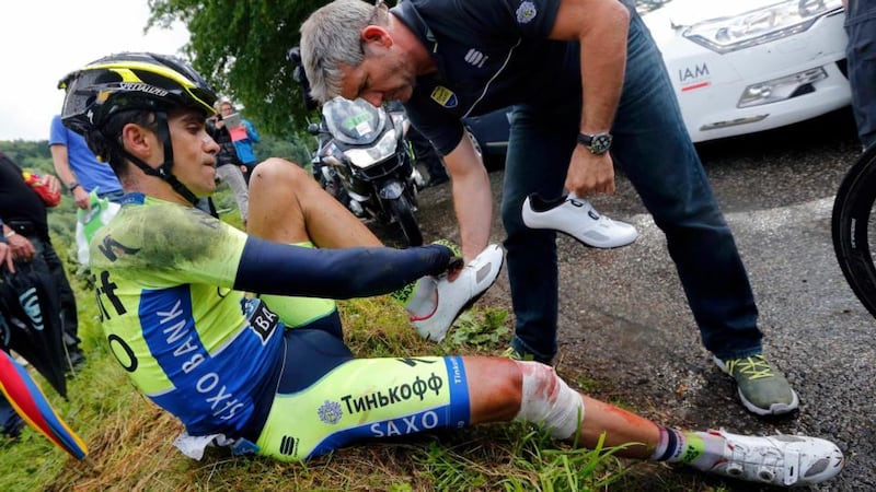 Tinkoff-Saxo team rider Alberto Contador of Spain gets medical assistance after he fell and broke his leg. Photograph: Jean-Paul Pelissier