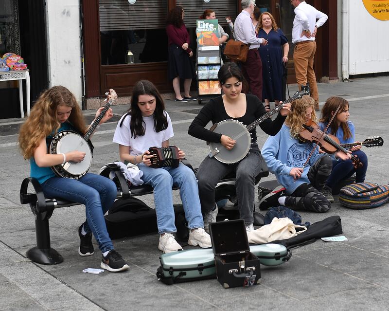 Young musicians take part in a street session at Fleadh 2022