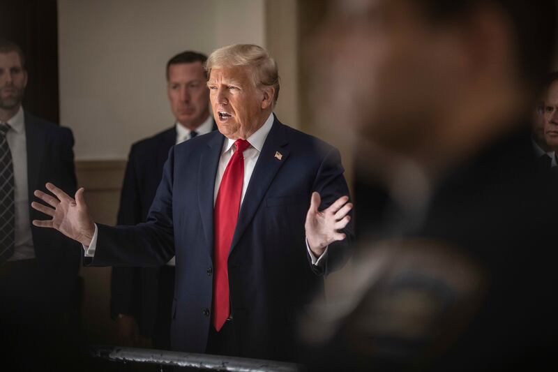 Donald Trump, accompanied by his son Eric Trump (left), speaks to reporters during the second day of his civil fraud trial last October. Photograph: Dave Sanders/The New York Times 